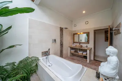 a large bathroom with a tub and a sink at Villa Kangaroo Seminyak next to double six beach in Seminyak