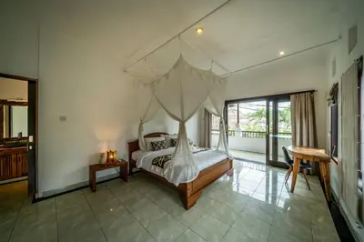 a bedroom with a bed with a canopy at Villa Panda Seminyak next to KU DE TA Beach Club in Seminyak