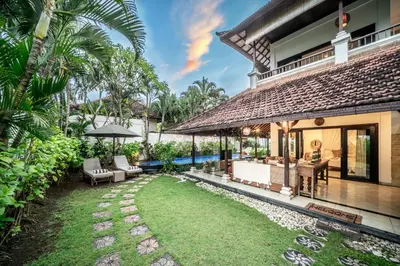 an outdoor patio of a house with a yard at Villa Panda Seminyak next to KU DE TA Beach Club in Seminyak