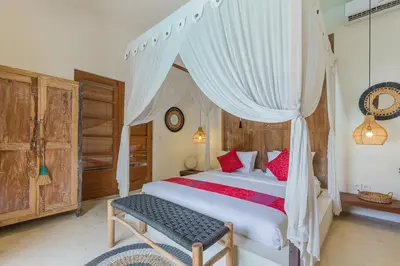 a bedroom with a large bed with a canopy at Luxury 3BR Villa Daenerys Pool Ricefield Family-Friendly Near Canggu in Kerobokan