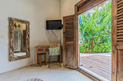 an open door to a room with a desk and a television at Luxury 3BR Villa Daenerys Pool Ricefield Family-Friendly Near Canggu in Kerobokan