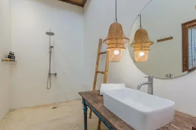a bathroom with a sink and a mirror at Luxury 3BR Villa Daenerys Pool Ricefield Family-Friendly Near Canggu in Kerobokan
