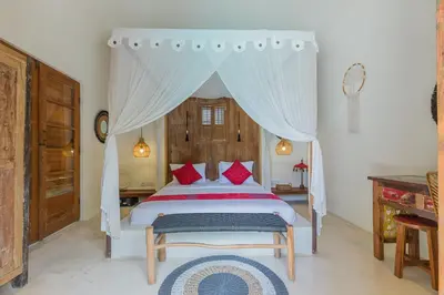 a bedroom with a bed with a canopy at Luxury 3BR Villa Daenerys Pool Ricefield Family-Friendly Near Canggu in Kerobokan