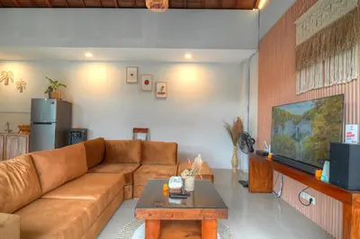 a living room with a couch and a coffee table at Villa O'Anne II in Seminyak