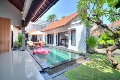 a pool in a villa with a pink pool noodle in the yard at Villa O'Anne II in Seminyak