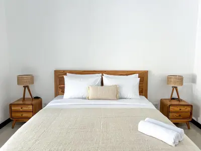 a bedroom with a large bed with two night stands at Luxe 2Bedrooms D Villa Berawa - Near Beach,FINNS & ATLAS in Canggu