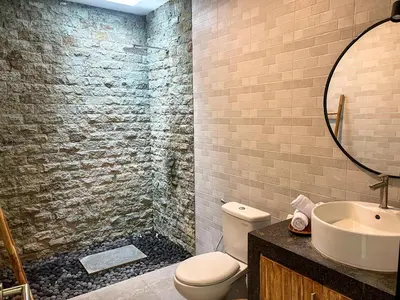 a bathroom with a toilet and a sink and a mirror at Luxe 2Bedrooms D Villa Berawa - Near Beach,FINNS & ATLAS in Canggu