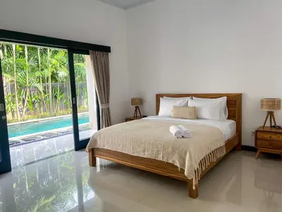 a bedroom with a bed and a large window at Luxe 2Bedrooms D Villa Berawa - Near Beach,FINNS & ATLAS in Canggu