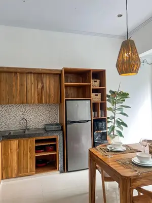 a kitchen with wooden cabinets and a stainless steel refrigerator at Luxe 2Bedrooms D Villa Berawa - Near Beach,FINNS & ATLAS in Canggu