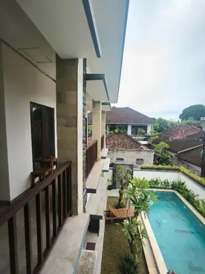a view from the balcony of a house with a swimming pool at Ken Ken Guest House in Seminyak