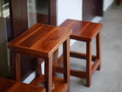 two small wooden tables sitting next to each other at Ken Ken Guest House in Seminyak