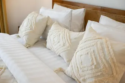 a white bed with white pillows on it at Villa Bella Wilson III in Seminyak