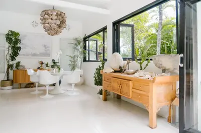 a living room with a table and chairs at Villa Kubu Lebak 3 in Seminyak