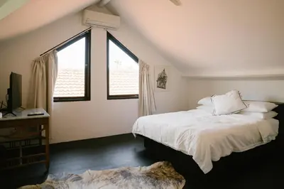 a bedroom with two beds and a large window at Villa Kubu Lebak 3 in Seminyak