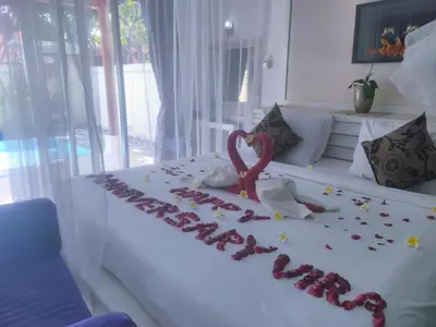 a white bed with a heart made out of roses at Classic Villa with Private Pool in Kuta