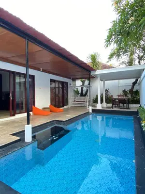 a swimming pool in front of a house at Classic Villa with Private Pool in Kuta