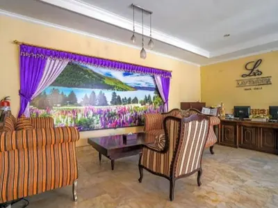a living room with two chairs and a table at Classic Villa with Private Pool in Kuta