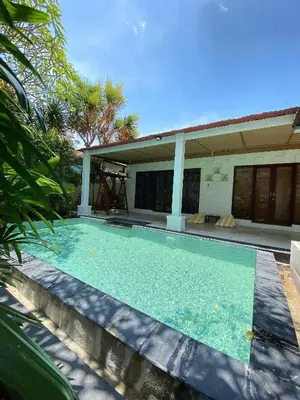 a swimming pool in front of a house at Classic Villa with Private Pool in Kuta
