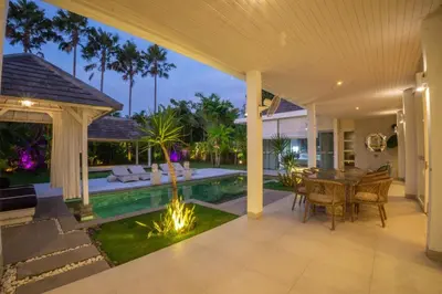 an open patio with a dining table and a pool at Bali Modern Escape With Private Pool, 8 guests in Kerobokan