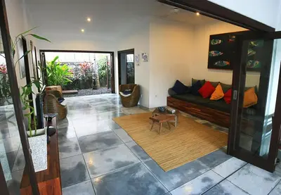 a living room with a couch and a table at Your Tropical Oasis Mason Villas Seminyak in Seminyak