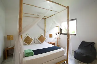 a bedroom with a bed with a canopy at Your Tropical Oasis Mason Villas Seminyak in Seminyak