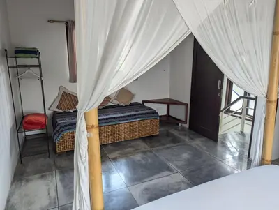 a bedroom with a bed with a canopy at Your Tropical Oasis Mason Villas Seminyak in Seminyak