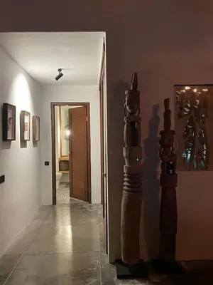 a room with a hallway with a door and some art on the wall at Top Villa Ilo, best area near canggu 250 m2 on 750 m2 land in Kerobokan