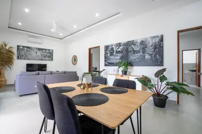 a dining room with a table and chairs at Aster Villa by iBali Management in Legian