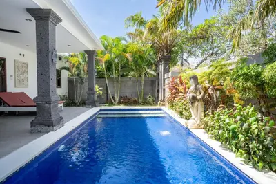 a swimming pool in the backyard of a villa at Melati Villa by iBali Management in Legian
