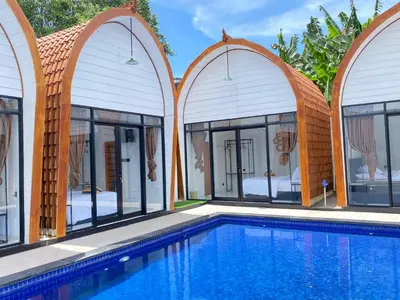 a villa with a swimming pool in a resort at HK Villa Family in Seminyak