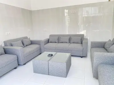 a living room with two couches and a coffee table at HK Villa Family in Seminyak