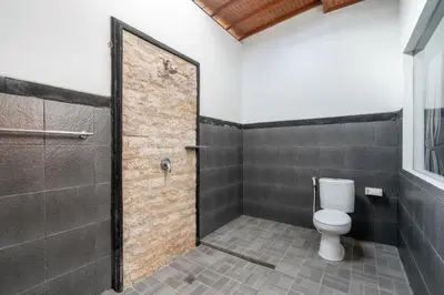 a bathroom with a toilet and a shower at 3 Bedroom Villa Mawar walk to Beach Legian in Legian