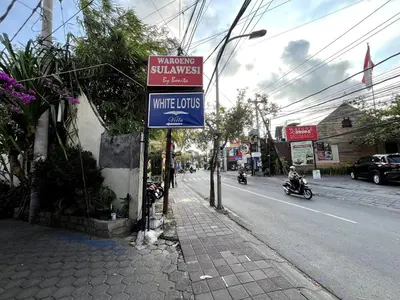 a street sign on the side of a street at White Lotus Villa by Miel Property in Seminyak