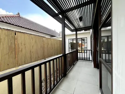 a balcony of a house with a wooden fence at White Lotus Villa by Miel Property in Seminyak