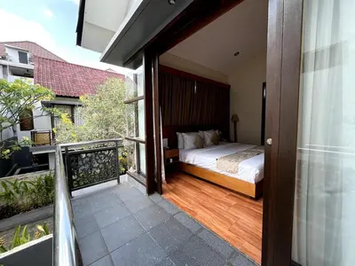 a bedroom with a bed on a balcony at Grand Kesambi Family Villa by Miel Property in Seminyak