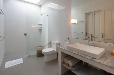 a white bathroom with a sink and a toilet at VILLA BELLA - 7Min Beach Access - 10min to Canggu in Canggu