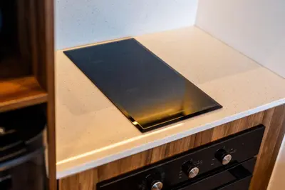 a black tablet sitting on top of a kitchen counter at Avanya Luxury Apartment by Pertama Management in Seminyak