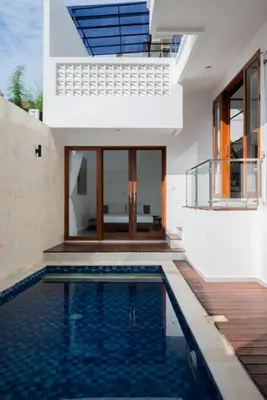 a house with a swimming pool in front of a house at Villa Manis with a private pool in Nusa Dua in Nusa Dua