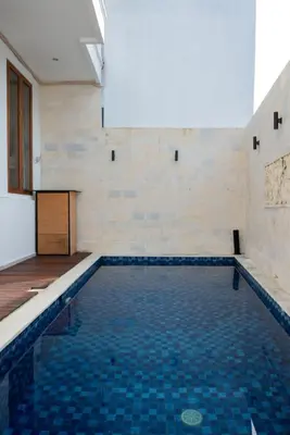 a swimming pool with a blue tiled floor at Villa Manis with a private pool in Nusa Dua in Nusa Dua