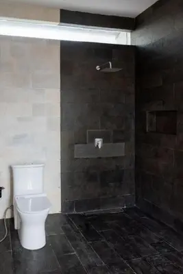 a bathroom with a toilet and a shower at Villa Manis with a private pool in Nusa Dua in Nusa Dua