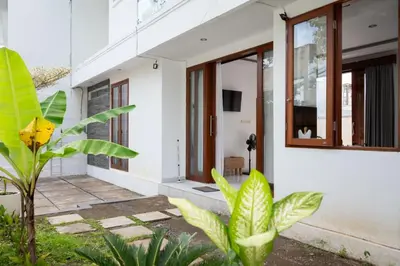 a white house with plants in front of it at Villa Manis with a private pool in Nusa Dua in Nusa Dua