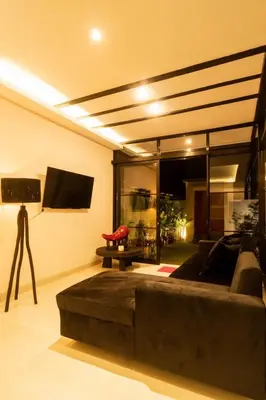 a living room with a couch and a flat screen tv at Stylish Umalas 2BR Villa With Private Pool in Kerobokan