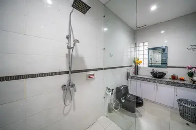 a bathroom with a shower and a toilet at KUTA - 3 Bedroom Private Pool Villa on Jl Mataram! in Kuta