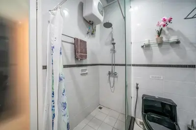 a bathroom with a shower with a glass door at KUTA - 3 Bedroom Private Pool Villa on Jl Mataram! in Kuta