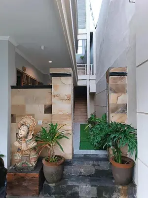 a staircase with potted plants in a building at Koura Jimbaran in Badung