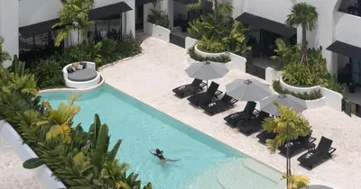 an overhead view of a pool with chairs and umbrellas at Kiara Ocean Place in Canggu