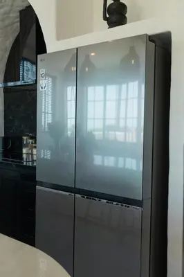 a refrigerator with glass doors in a kitchen at Kiara Ocean Place in Canggu