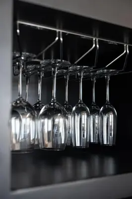 a row of wine glasses on a rack in an oven at Kiara Ocean Place in Canggu