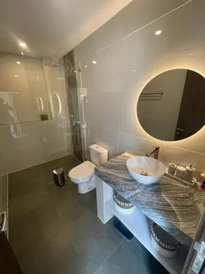 a bathroom with a sink and a toilet and a mirror at Cozy 3 Bedrooms Villa Umalas in Kerobokan