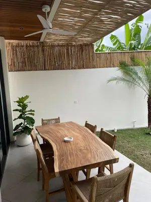 a dining room table with chairs and a ceiling fan at Cozy 3 Bedrooms Villa Umalas in Kerobokan